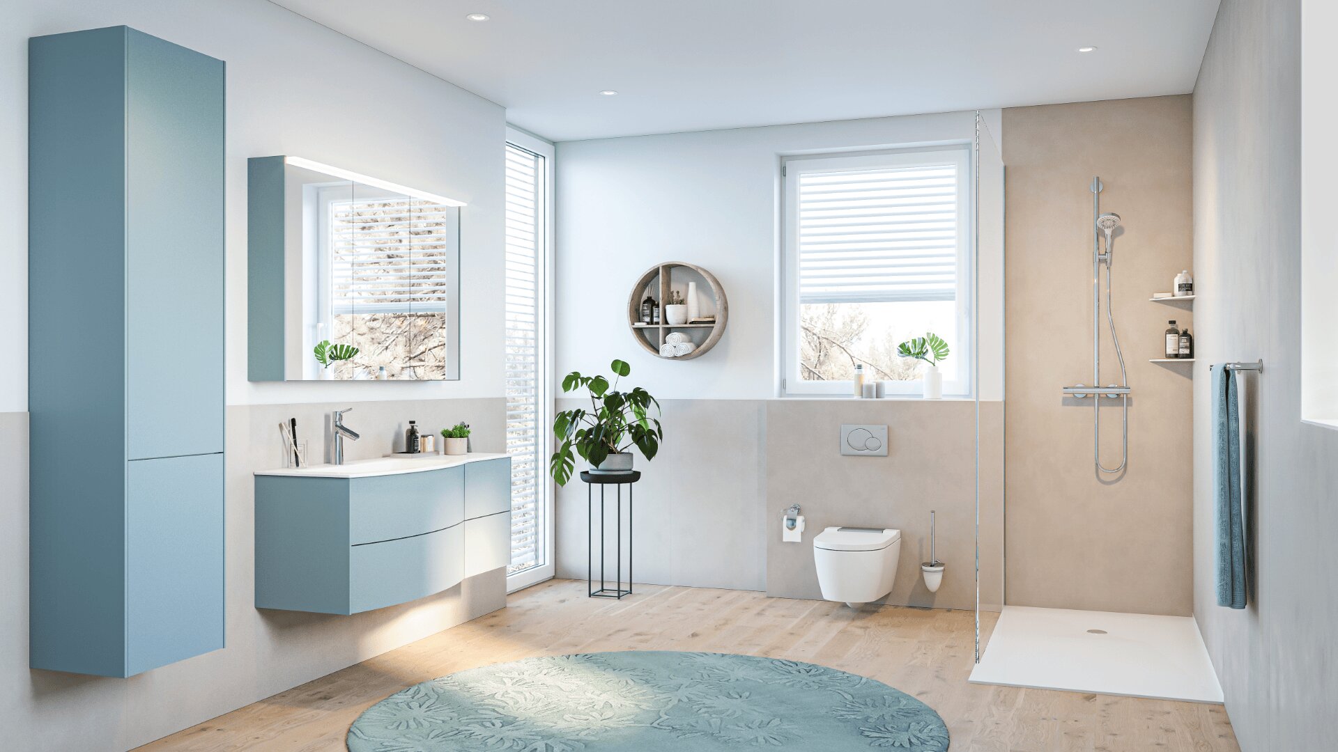 Modernes Badezimmer mit hellblauen Schränken, wandmontiertem Waschbecken, rundem grünen Teppich, großem Fenster, begehbarer Dusche, wandmontierter Toilette und Zimmerpflanzen. Der Raum ist hell mit natürlichem Licht und minimalistischem Dekor.