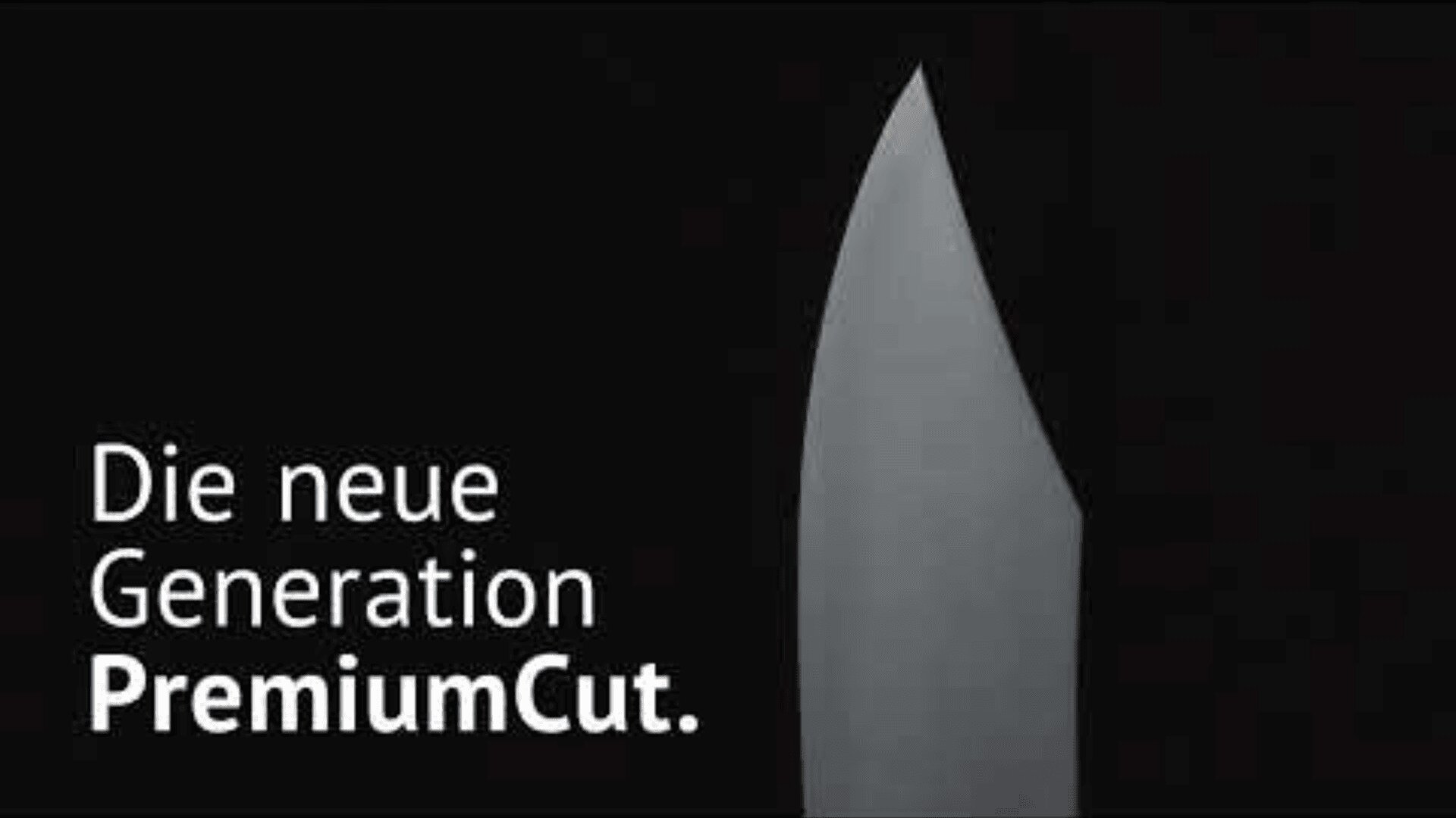 Eine schlanke Messerklinge ist auf schwarzem Hintergrund abgebildet, mit dem deutschen Text Die neue Generation PremiumCut. in Weiß auf der linken Seite.